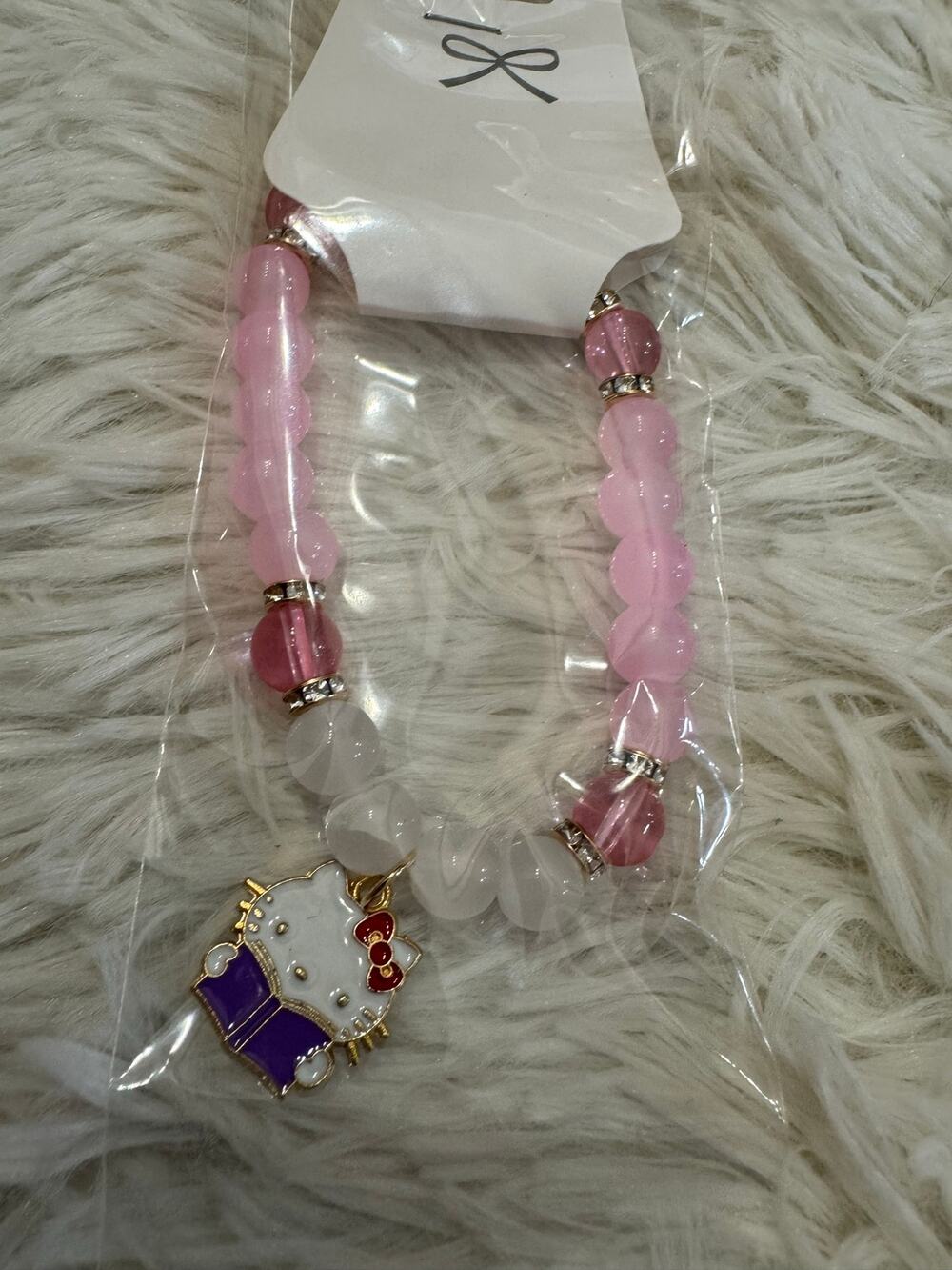 Hello Kitty pink beaded bracelet with Hello Kitty reading charm